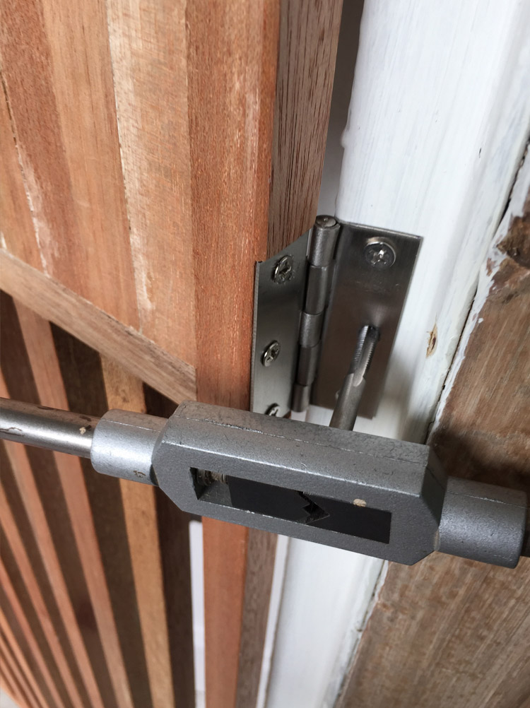 Fixed hinge onto the wooden gate before installation. Mark and drill holes and then tap thread for flatted screw
